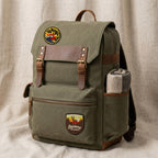 outdoor embroidered stick-on patches on a vintage canvas backpack with leather straps