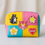 embroidered stick-on patches on a colorful color-block makeup pouch