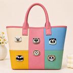 panda hedgehog and raccoon face stick-on patches decorating a pink color-block leather handbag