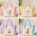 Four pastel tote bags displaying embroidered bunnies with carrots, flowers, mustard clothing, and winter accessories
