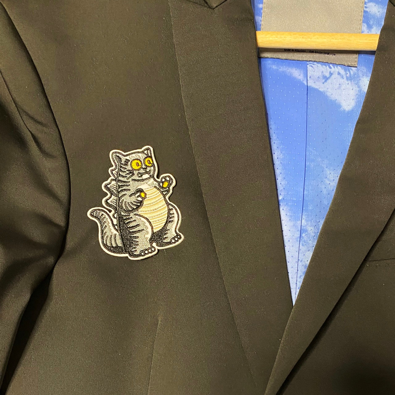 cat godzilla embroidered patch on a jacket