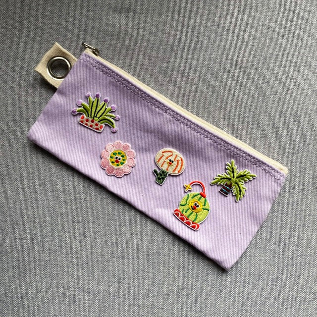 groovy plant and flower embroidered patches on a lavender canvas pencil case