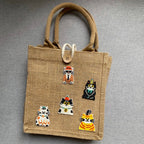 dapper cat embroidered patches in costumes on a burlap tote bag