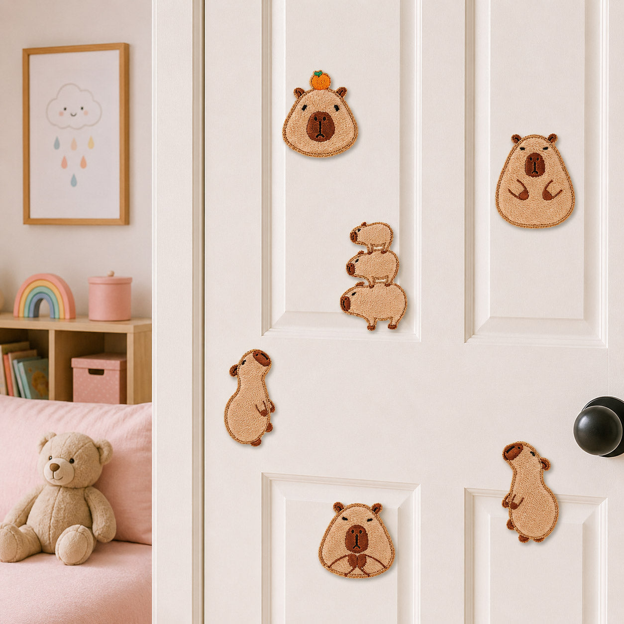 six capybara embroidered patches in various poses stuck on a white door in a pink kids room