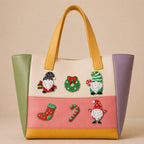 Christmas gnome wreath and candy cane stick-on patches decorating a colorful color-block leather handbag
