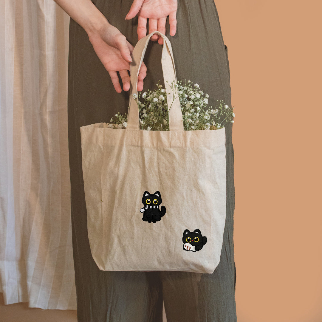 cozy black cat embroidered stick-on patch on reusable bag