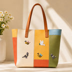white peace dove with olive branch and yellow bumblebee stick-on patches decorating a multicolor stripe leather handbag