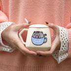 sad light blue teacup cat embroidered patch on mug