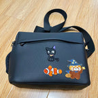 cat's diary embroidered patch on a camera bag