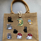 hungry and sleepy cat embroidered stick-on patch on a jute tote bag