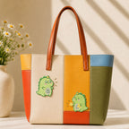 fluffy green dinosaur surprised and holding a star stick-on patches decorating a multicolor stripe leather handbag