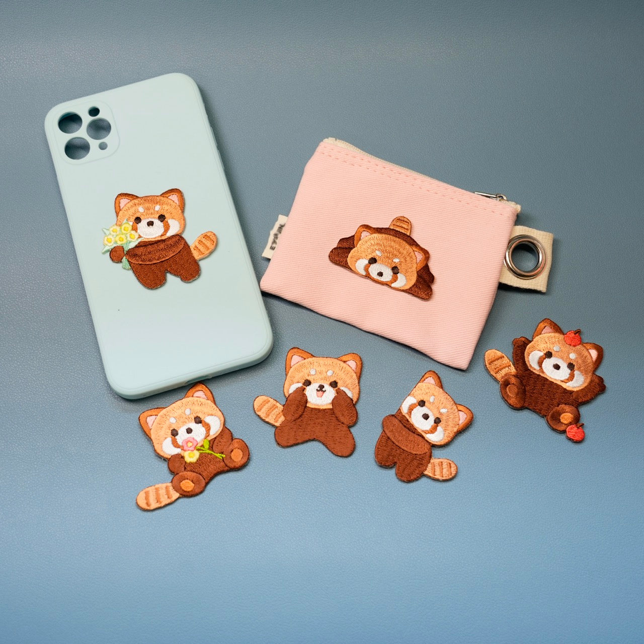 multiple red panda patch stickers on a phone case and card holder