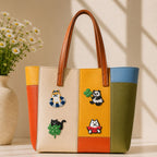 shiba inu black cat panda and dog with swim ring clover and watermelon stick-on patches decorating a multicolor stripe leather handbag