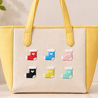 cute heart stocking embroidered stick-on patches on yellow canvas tote bag — six colour stockings arranged in a grid red sky blue coral pink black yellow mint green
