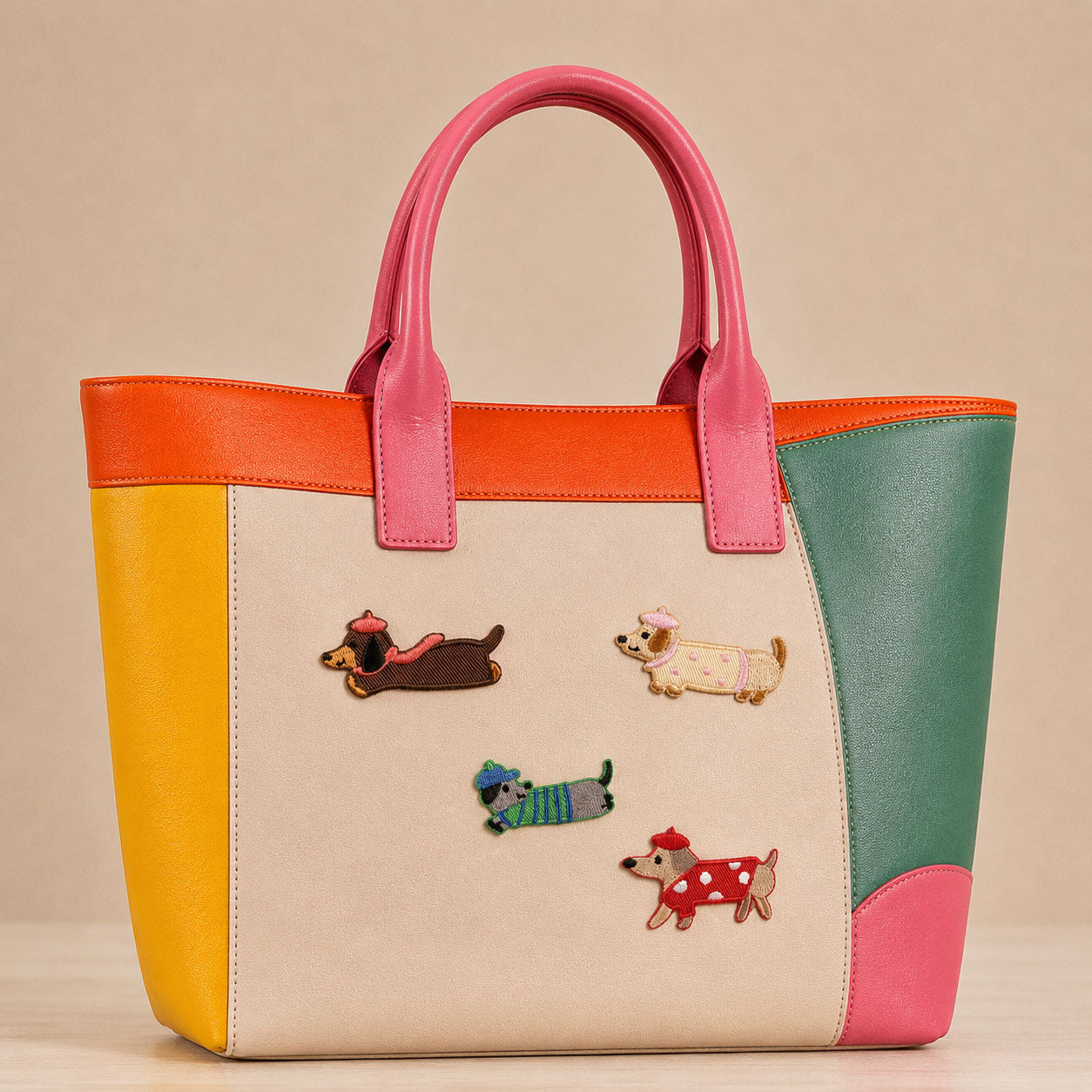 dachshund in beret chef hat and polka dot dress stick-on patches decorating a pink and orange color-block leather handbag