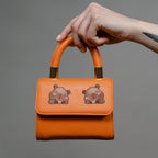 derpy capybara embroidered patch sticker on a handbag