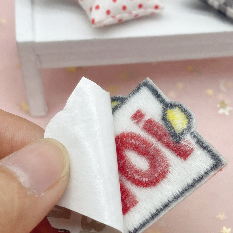 peeling the backing off a yes or no duck embroidered stick-on patch