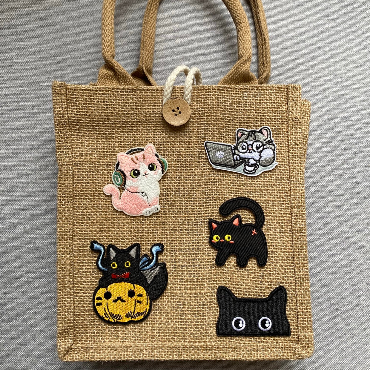 kawaii music-loving cat embroidered stick-on patch on a jute tote bag