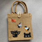 whimsical cat apparel embroidered stick-on patch on a jute tote bag