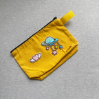celestial planet and candy heart embroidered patches on a mustard yellow canvas pouch