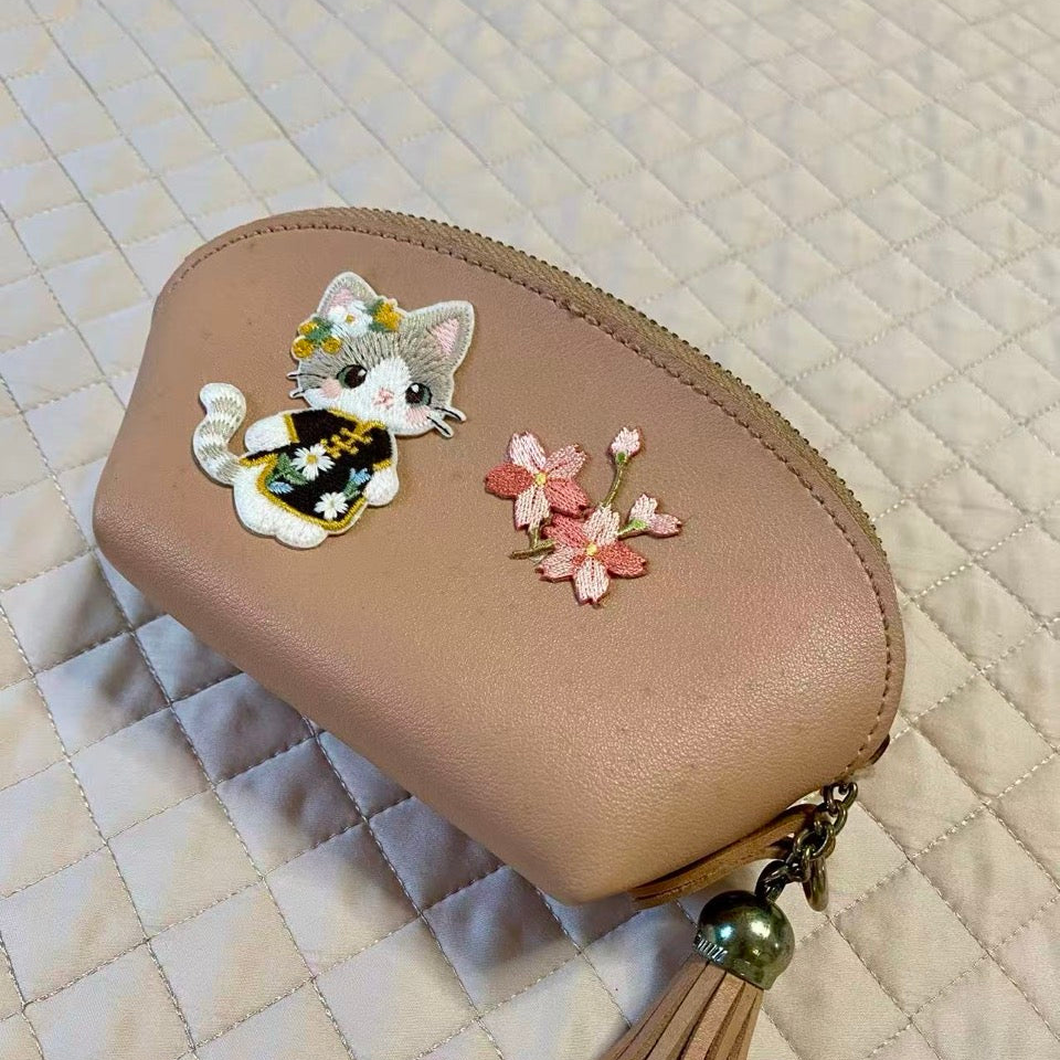Cherry blossom bouquet stick-on patch on a makeup pouch