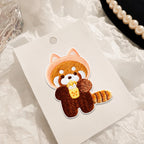 red panda drinking boba tea embroidered stick-on patch on display card — warm tones with pearl and glass styling