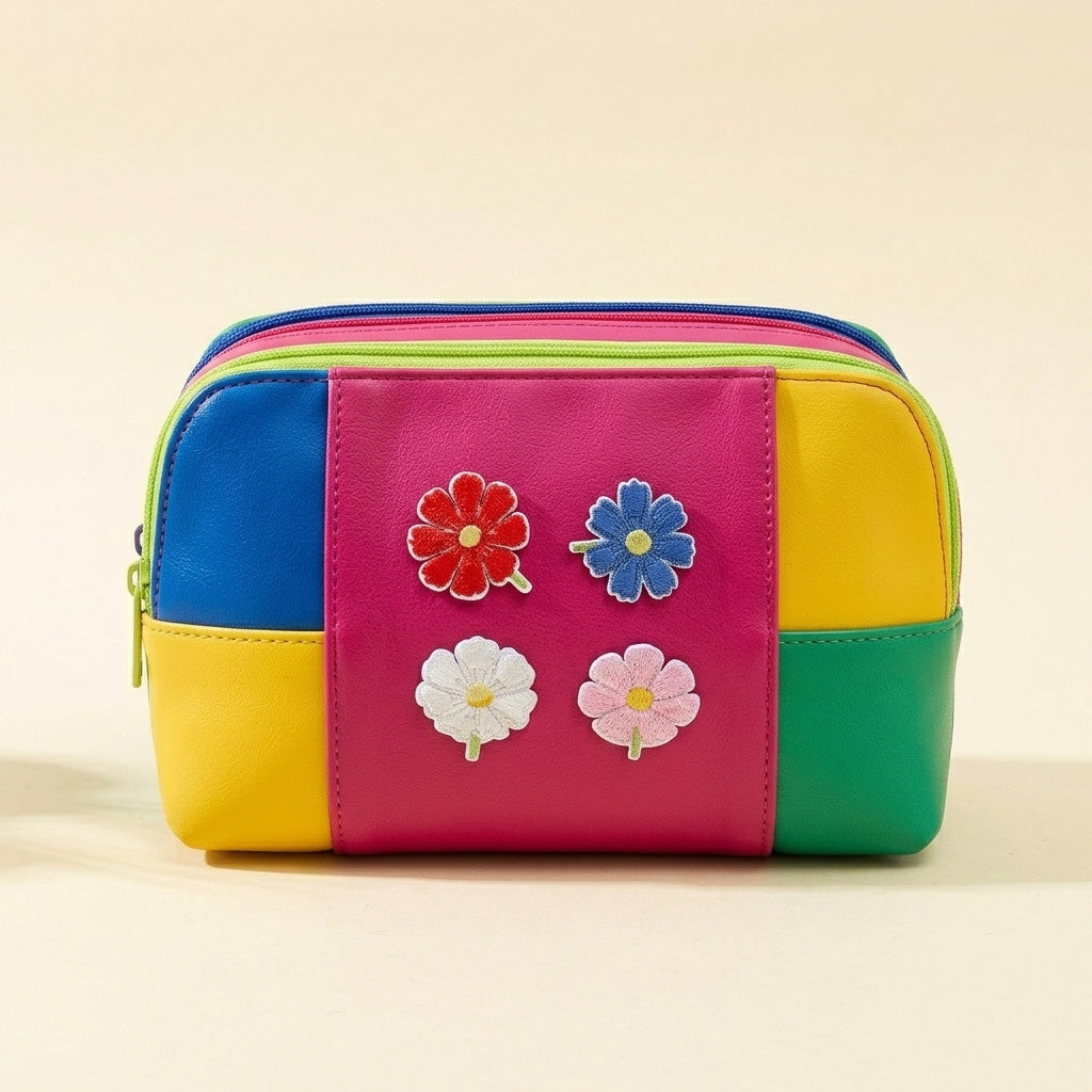 red blue white and pink cosmos flower stick-on patches decorating a colorful color-block leather pouch