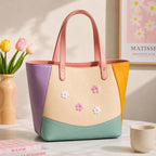 blush and white sakura cherry blossom embroidered patches on a pastel color-block leather tote bag