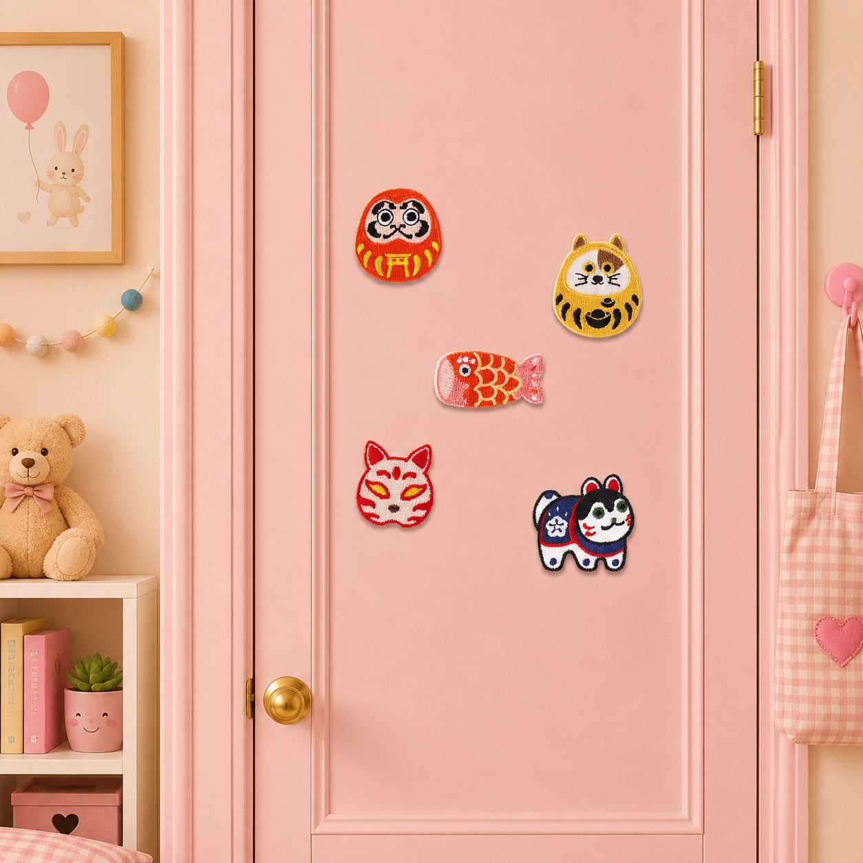 red daruma doll golden cat daruma red koi with cherry blossom scales fluffy fox mask and blue inu hariko dog stick-on patches on a pink door in a pastel room