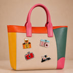 retro film camera polaroid and flash camera stick-on patches decorating a pink and orange color-block leather handbag