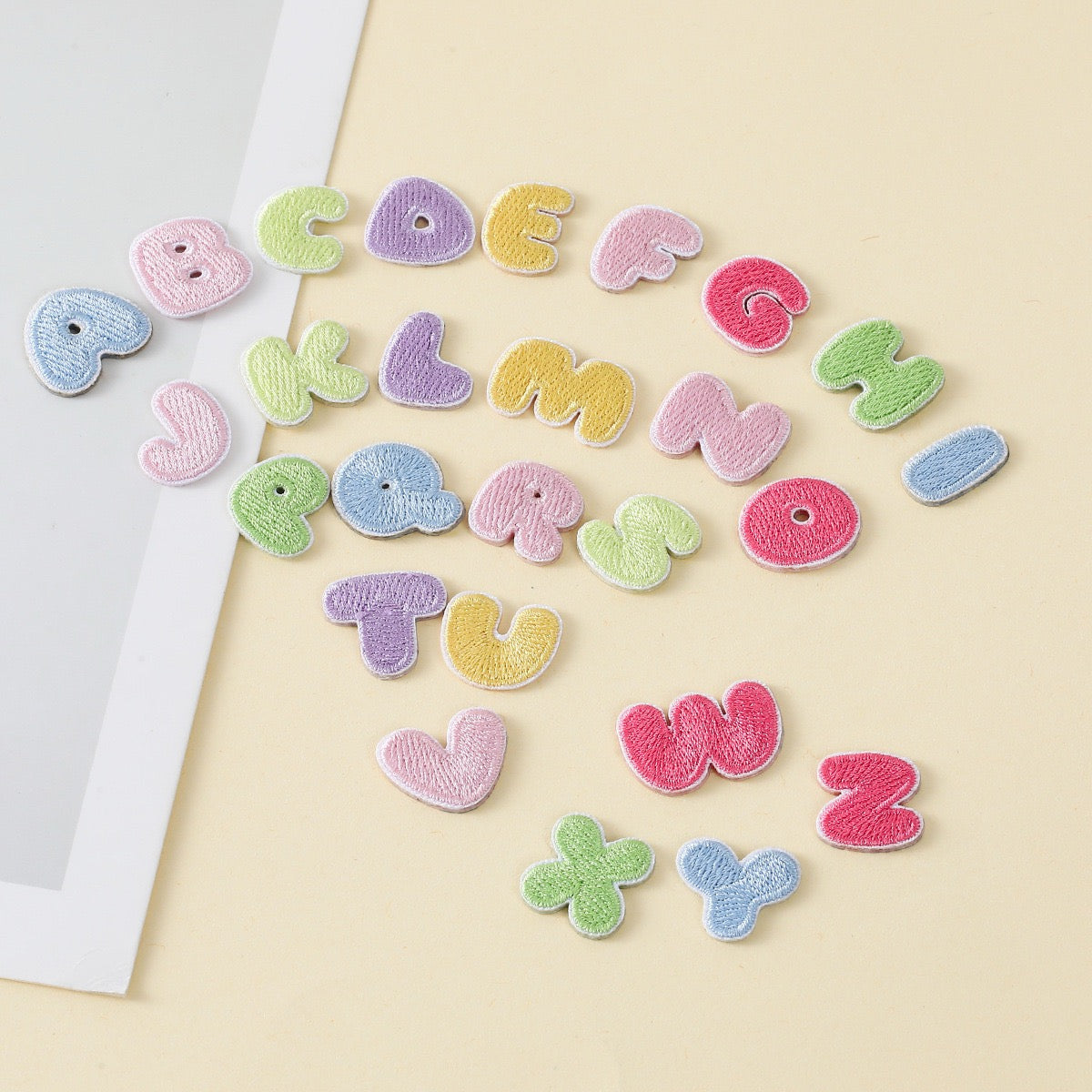 pastel macaroon mini alphabet embroidered stick-on patches full set flat lay
