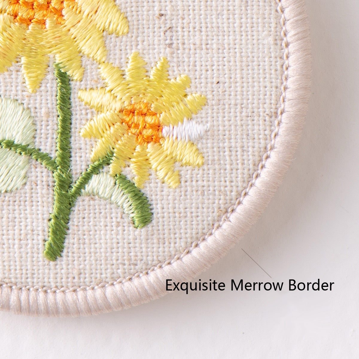 close-up embroidery detail of botanical floral double-sided keychain charm
