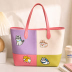 tabby cat and shiba inu stick-on patches decorating a purple and pink color-block leather handbag