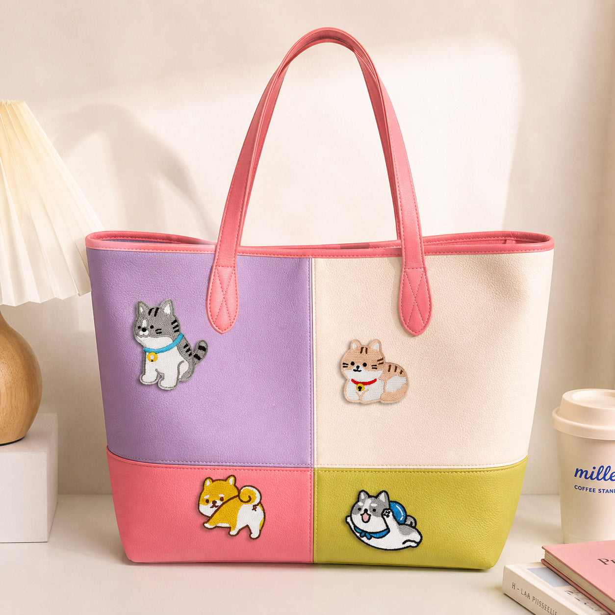 tabby cat and shiba inu stick-on patches decorating a purple and pink color-block leather handbag