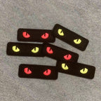 glow-in-the-dark cat eye embroidered stick-on patches flat lay on table