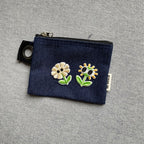 googly eyes flower embroidered patches on a dark denim coin pouch