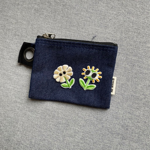 googly eyes flower embroidered patches on a dark denim coin pouch