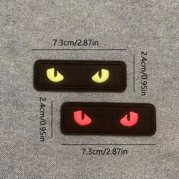 two glow-in-the-dark cat eye embroidered stick-on patches — yellow and red complete set