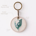 full view of botanical floral double-sided embroidered keychain charm with antique bronze hardware