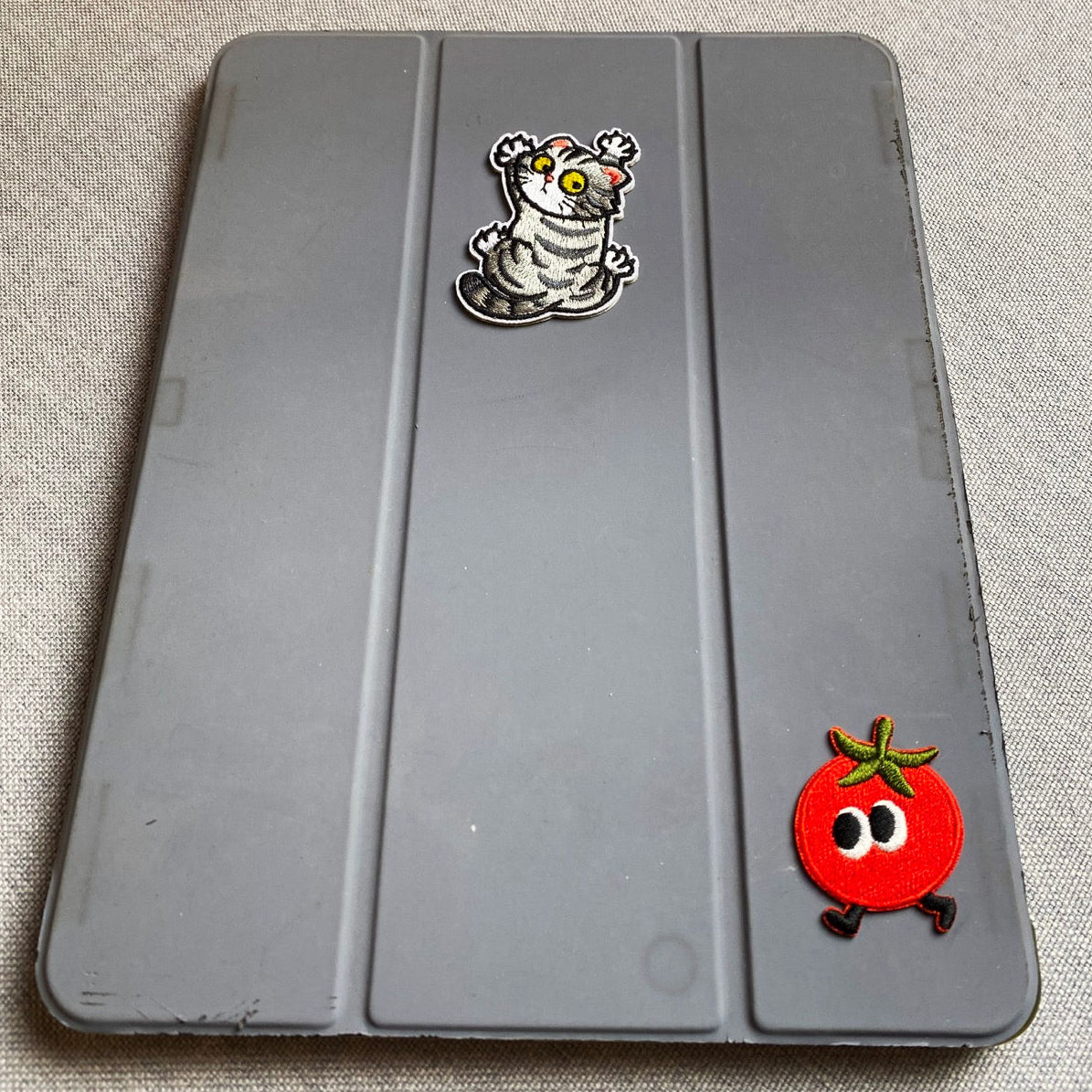 whimsical embroidered stick-on patches decorating an iPad case