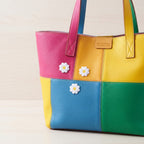 mini white daisy embroidered stick-on patches on bag
