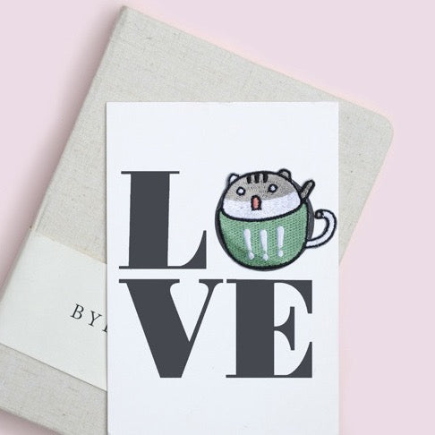 exclamation green teacup cat embroidered patch on journal cover letter O