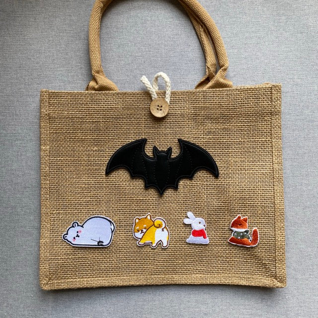 cozy winter fox and rabbit embroidered stick-on patches on a jute tote bag