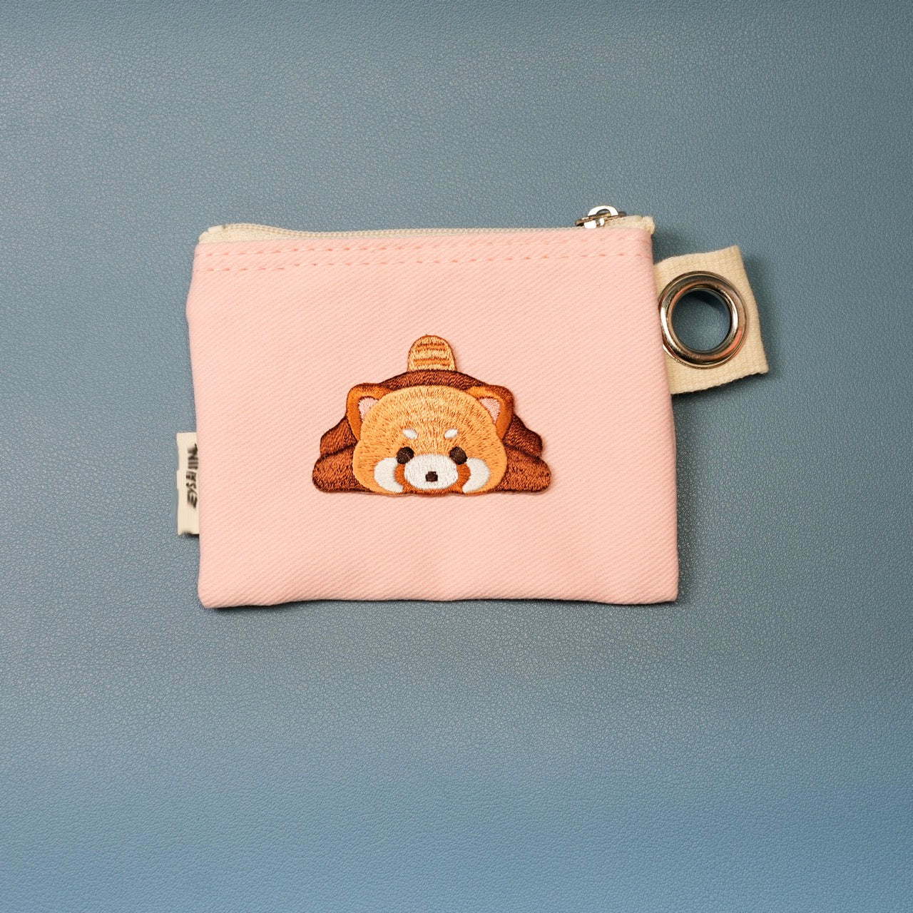 adorable red panda stick-on patch on a card holder wallet