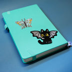 Halloween black cat embroidered patch sticker on a notebook