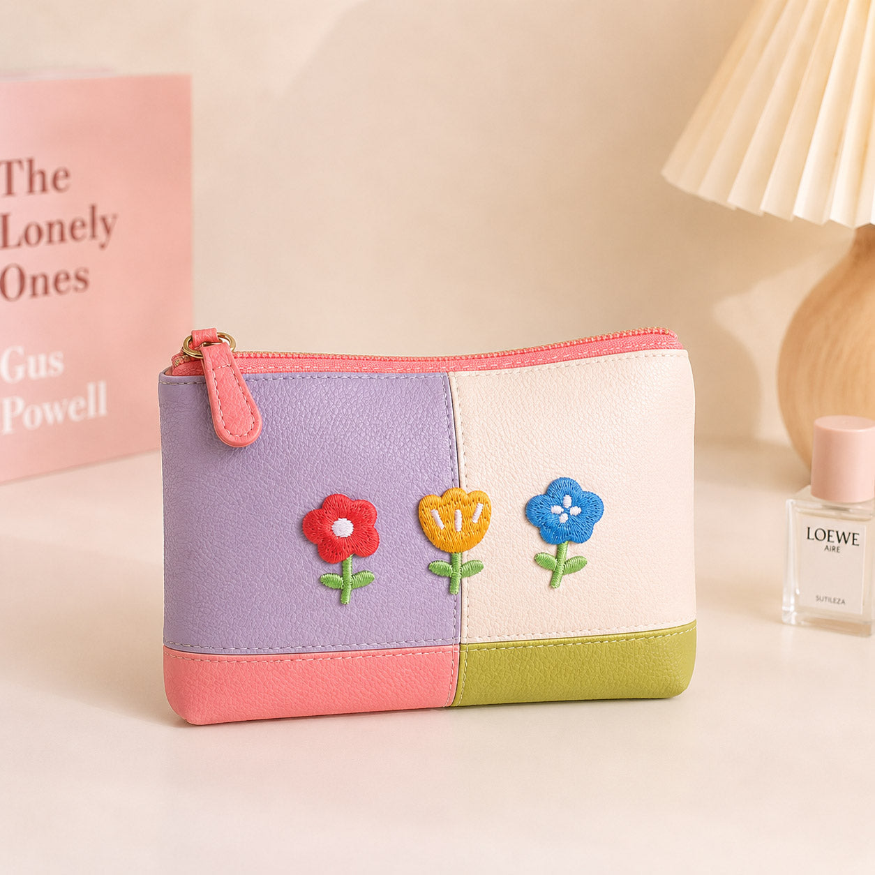 three kawaii spring flower embroidered patches on a pastel color-block leather coin pouch