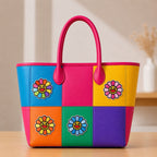 colorful smiley sunflower stick-on patches decorating a vibrant color-block leather handbag