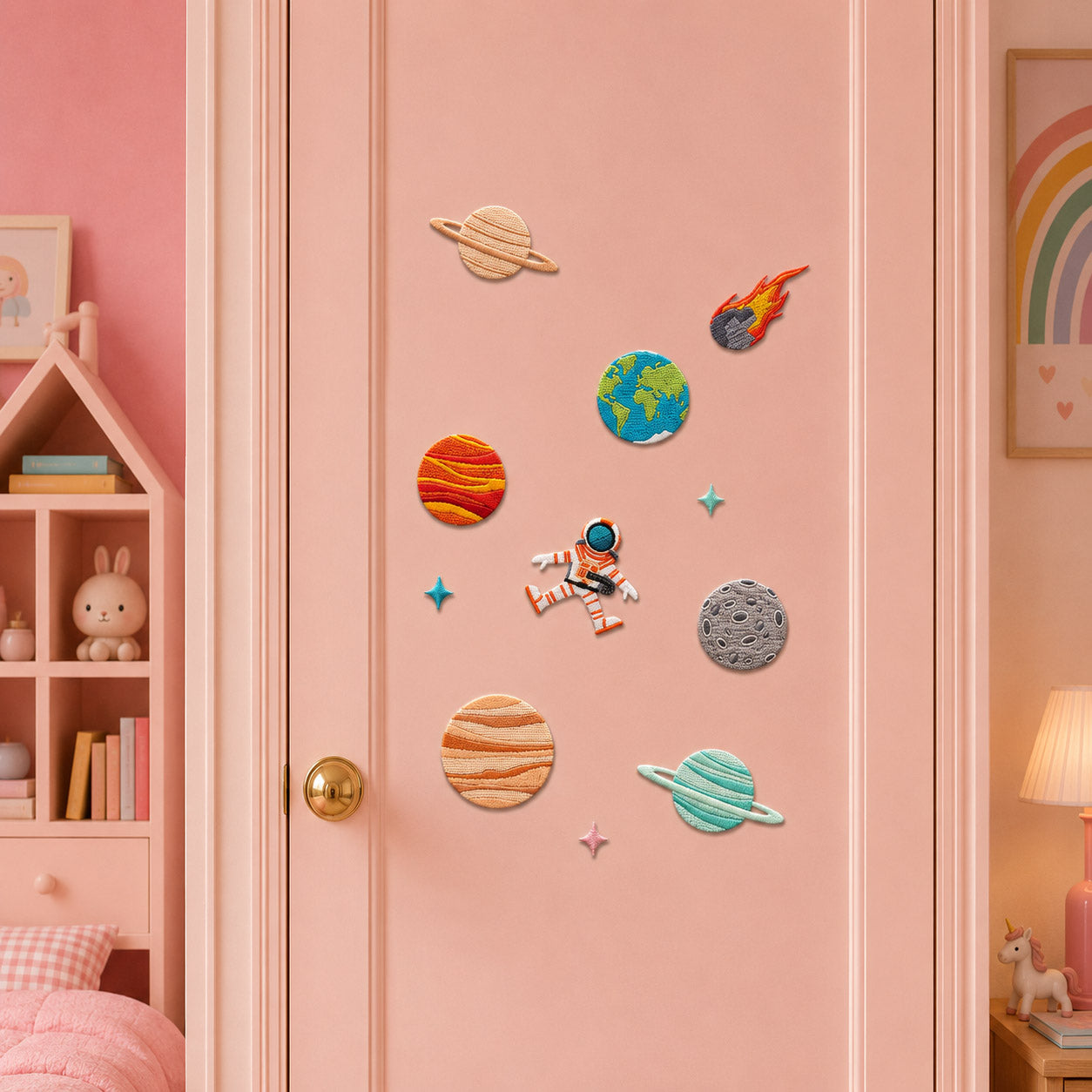 realistic planet patches including saturn jupiter earth moon and flaming meteor with floating astronaut and star stick-on patches on a pink door in a girls room
