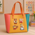 bear cat squirrel and bunny with flowers stick-on patches decorating an orange and yellow color-block leather handbag