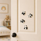 four fuzzy panda kung fu embroidered patches in standing rolling and sitting poses on a white door seen from a kids bedroom